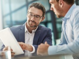 Noch mehr Nähe, noch kürzere Wege Tablet, Treffen von zwei Geschäftsleuten in der Bürodiskussion