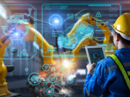 Arbeitsabläufe modern gestalten durch Prozessdigitalisierung Ein Mann steht vor einer Glaswand in der Produktion.