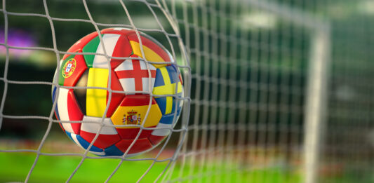 Fußball EM 2024: Mitfiebern und gewinnen Fußball mit Flaggen von europäischen Ländern im Netz der Tore des Fußballstadions.
