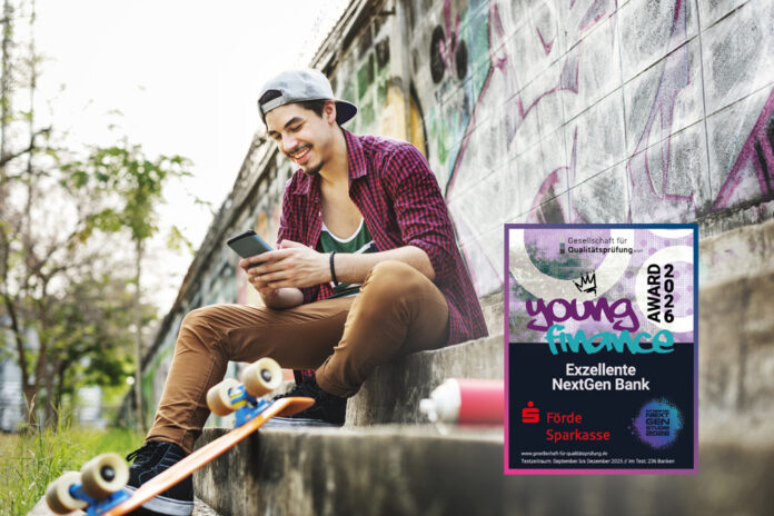 Ein Teenager sitzt mit seinem Skateboard vor eine Graffiti Wand.