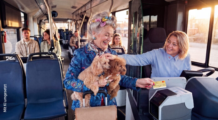 Bargeldlos zahlen in KVG-Bussen Eine ältere Dame hat zwei Hunde auf dem Arm und bezahlt in einem Bus mit ihrer Kreditkarte. Die Busfahrerin lächelt und streichelt die Hunde.